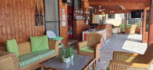 a patio with chairs and a couch and a table at Anna Hotel Apartments in Paphos City