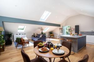 a kitchen and living room with a table and chairs at Bowland Lodges in Lancaster