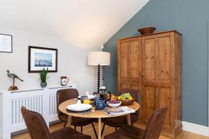 a dining room with a wooden table and chairs at Bowland Lodges in Lancaster