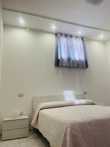 a bedroom with a bed and a window at Casa Vacanze "LE DUE RONDINI" in Venosa +5 photos