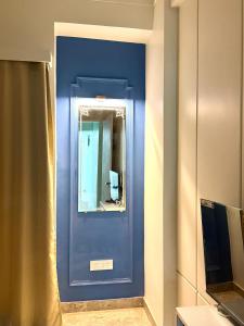 a blue door with a mirror in a room at The Olivia by Shri Hari Groups in Rishīkesh +5 photos