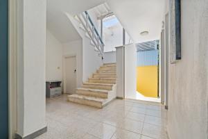 a hallway with a staircase in a house at Hotel Selini in Agios Nikitas