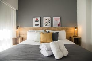 a bedroom with a large bed with towels on it at El Misti Suites Buenos Aires in Buenos Aires +61 photos