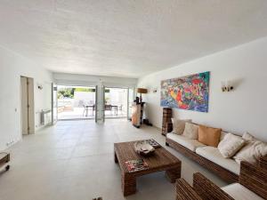 a living room with a couch and a table at House T3 with Sea View and Private Pool - 5 minutes walk from the beach in Sesimbra