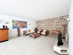 a living room with a couch and a tv at House T3 with Sea View and Private Pool - 5 minutes walk from the beach in Sesimbra