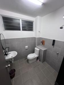 a bathroom with a toilet and a sink at berTIGA Homestay Bertam in Kepala Batas
