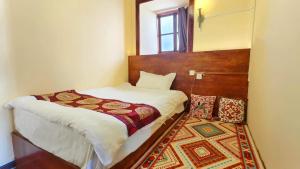 Postel nebo postele na pokoji v ubytování Shangri-La Youran Valley Inn