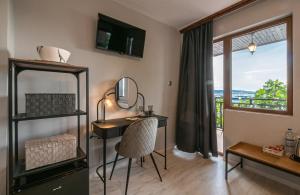 a room with a desk with a chair and a window at Guest House Fotini 2 in Sozopol
