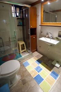 a bathroom with a toilet and a sink and a shower at Villa Helios in Kandia