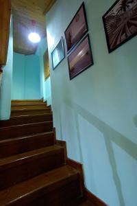 a hallway with stairs and pictures on the wall at Villa Helios in Kandia