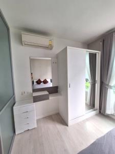 Ένα ή περισσότερα κρεβάτια σε δωμάτιο στο Bless Condo ดีคอนโดฮาย เชียงราย