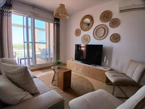 a living room with a couch and a tv at Casa Bella Vista in Alhama de Murcia