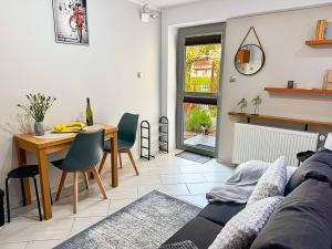 a living room with a couch and a table at Apartamenty Tercet, Apartament Kwartet, Apartament DUO in Ustka