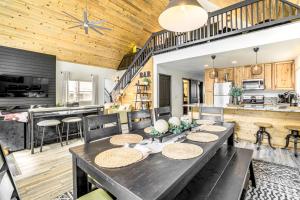 a dining room and kitchen with a wooden ceiling at Walk to Trails Modern Munds Park Mountain Retreat in Munds Park