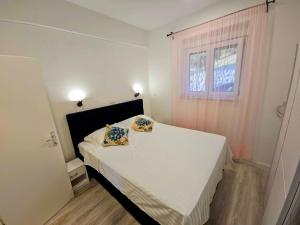 a bedroom with a bed with two pillows on it at Apartment Nemo in Jesenice