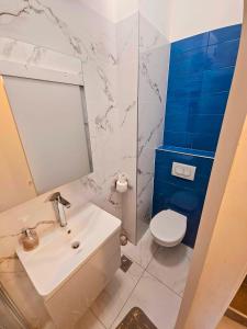 a bathroom with a white sink and a toilet at Apartment Nemo in Jesenice