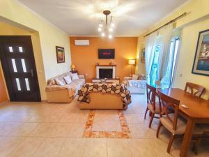 a living room with a couch and a table at The View Point apartment 2 in Agios Ioannis