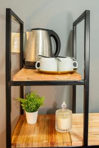 a shelf with two pots and a tea kettle at El Misti Suites Buenos Aires in Buenos Aires
