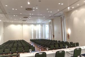 an empty auditorium with green chairs and tables at Hotel Torres da Cachoeira in Florianópolis +30 photos