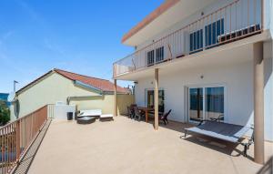 a balcony of a house with a patio at 1 Bedroom Lovely Apartment In Brodarica in Brodarica +16 photos