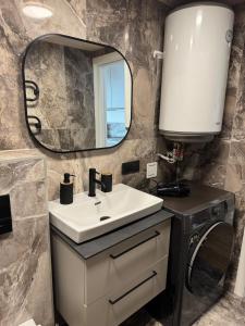 a bathroom with a sink and a mirror at Seaside apartment x Monciškės in Palanga +26 photos
