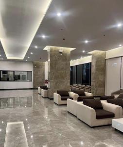 a lobby with couches and chairs in a building at Regent Home Bangna Huge Bedroom Condo in Bang Chak