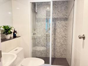 a bathroom with a shower with a toilet and a sink at Regent Home Bangna Huge Bedroom Condo in Bang Chak +36 photos