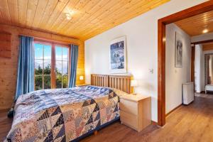 a bedroom with a bed and a window at Marcotte - 8 pers - belle vue in Nendaz