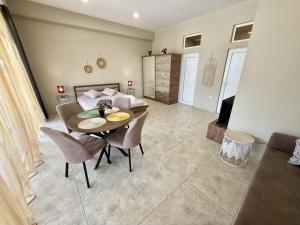 a living room with a table and chairs and a bed at NM Residence in Shkorpilovtsi