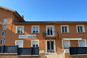 a large orange building with a sign on it at Résidence Dalma - Appartement 5 - pour cure thermale in Cazaubon +4 photos
