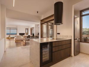 une cuisine avec un comptoir et un salon dans l'établissement Aeri Residence, à La Canée