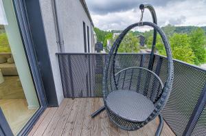 a chair on a balcony with a swing at Premium apartment x free parking x 24x7 in Vilnius