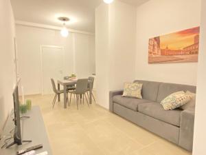 a living room with a couch and a table at Suite Emilia 1 in Bologna