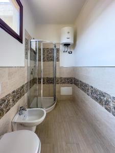 a bathroom with a shower and a toilet and a sink at Casa Helios in Sassari +14 photos