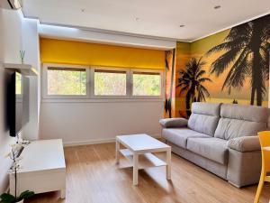 a living room with a couch and a table at Color Suites Alicante in Alicante