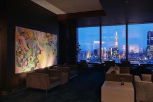 a room with couches and a large painting on the wall at Park Hotel Tokyo in Tokyo