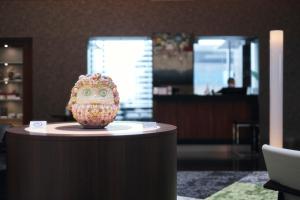 a vase sitting on a table in a room at Park Hotel Tokyo in Tokyo