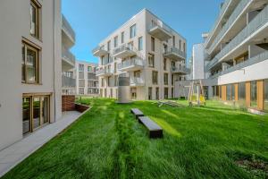 an apartment yard with benches in the middle of a building at EXQUIS Design 2BR Apartment HANSEN I Balcony I Mercedes & US Army I Parking I Stuttgart in Böblingen