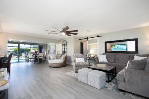 a living room with a couch and a tv at A Splash Of Water - Family-Friendly Retreat with Private Heated Pool and Lakefront View in Fort Myers