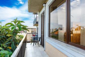 a balcony with a table and chairs and a view of the city at Golden Pheasant in Tbilisi City