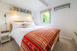 a bedroom with a bed in a small room at A Duke's Spectacular grand folly - The Temple in Euston +29 photos