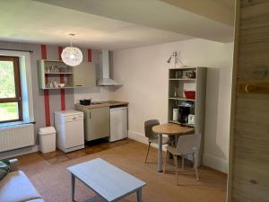 a kitchen and dining room with a table and a tablektop at Odcvl - Le Moulin Gentrey in Harsault +8 photos