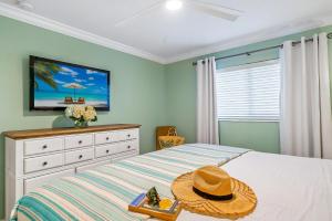 a bedroom with a bed with a hat on it at Crescent Royale Condominiums 105 in Siesta Key +51 photos