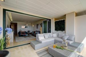 a living room with a couch and a table at Ribera del Marlin IX Sotogrande in Sotogrande