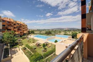 a view of the pool from the balcony of a apartment at Ribera del Marlin IX Sotogrande in Sotogrande