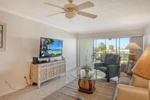 a living room with a tv and a couch at Crescent Royale Condominiums 205 in Siesta Key