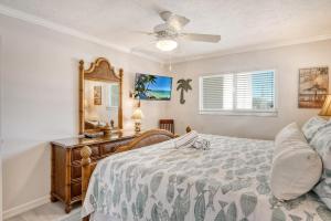 a bedroom with a bed and a dresser and a mirror at Crescent Royale Condominiums 205 in Siesta Key +44 photos
