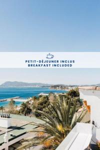 a view of the beach from the balcony of a resort at Hôtel Les Voiles in Toulon