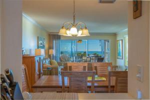 a dining room and living room with a table and chairs at Crescent Royale Condominiums 301 in Siesta Key