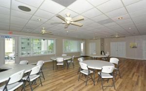 a room with tables and chairs and a ceiling fan at Crescent Royale Condominiums 301 in Siesta Key +77 photos